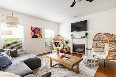 Living room featuring ceiling fan and light hardwood / wood-style floors