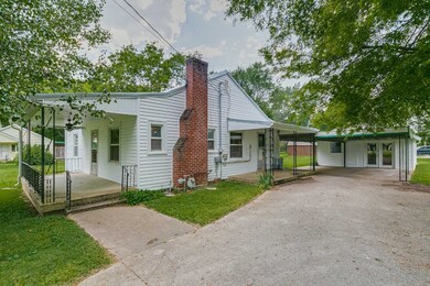 Awesome covered rocking chair porches on two sides, carport, and detached workshop.