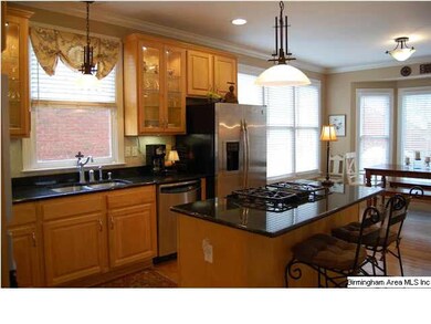 Beautiful kitchen featuring custom cabinetry, gran
