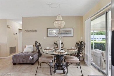 Tiled dining room featuring a notable chandelier
