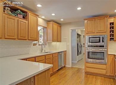 Kitchen has extensive counter space, double ovens and views of the peaceful  backyard.