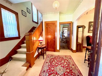 The stately entry with gorgeous custom woodwork we