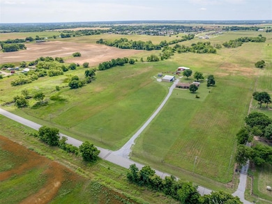 Aerial view of property and surrounding area featuring rural landscape