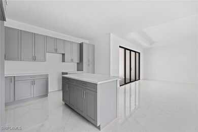 Kitchen with a center island and gray cabinets