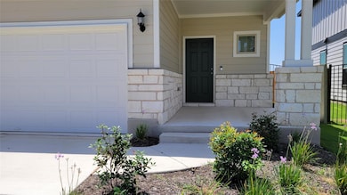 Doorway to property featuring stone siding and a 