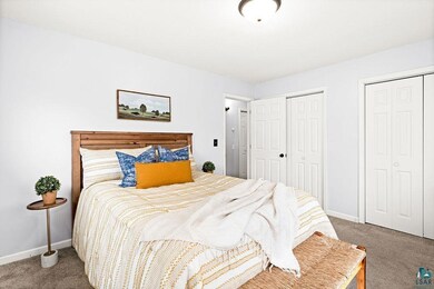 Bedroom featuring multiple closets and carpet
