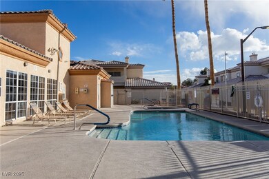 Pool with a patio and fence