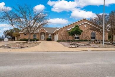 View of front of house featuring driveway, brick 