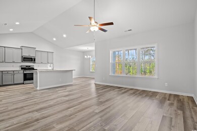 Kitchen featuring gray cabinetry, ceiling fan with