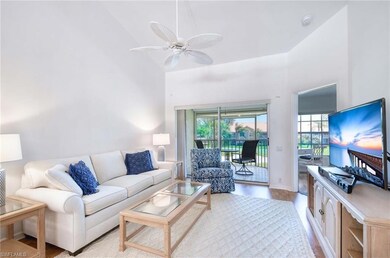 Living room featuring a high ceiling, light wood-s