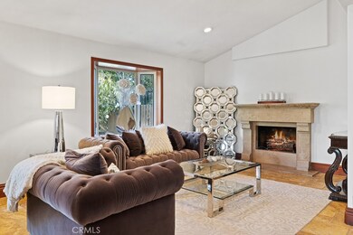 To the rigth of entry is the more formal but cozy living room with fireplace.