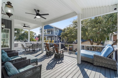 Deck with outdoor dining space, a ceiling fan, and outdoor lounge area