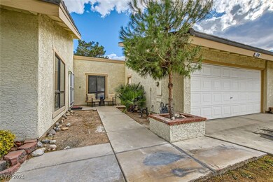 Entrance to property featuring concrete driveway,