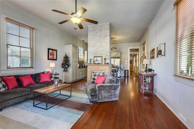 11ft ceilings soaring above original hardwood floo