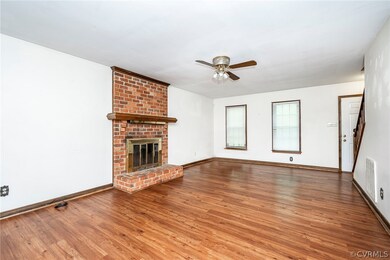 Unfurnished living room with brick wall, a brick f