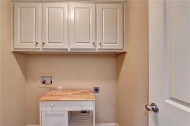 Clothes washing area with cabinet space, hookup fo