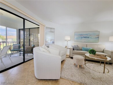 Living room with ceiling fan and light tile patter