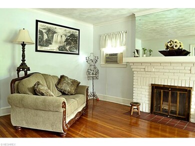 Beautiful hardwoods thru-out. Wood burning Fireplace, with large mantle and Huge mirror! Lots of space and has open concept to the Dining area