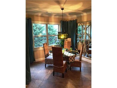 Dining Room. Light and bright breakfast area with access to back brick terrace.