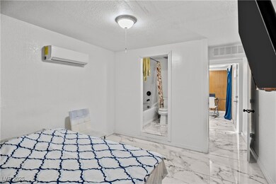 Unfurnished bedroom with a textured ceiling, a wal