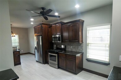 Kitchen area complete with fridge