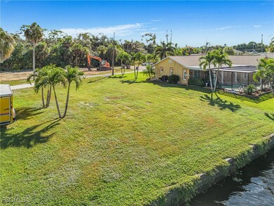 View of green lawn with glass enclosure, a sunroom, and a water view