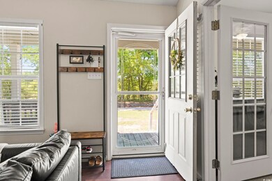 Doorway with dark wood-style flooring and a healthy amount of sunlight