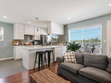 Kitchen featuring stainless steel fridge, open fl