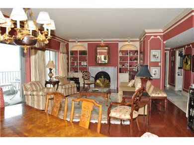 A fireplace, dining room and two balconies to ente