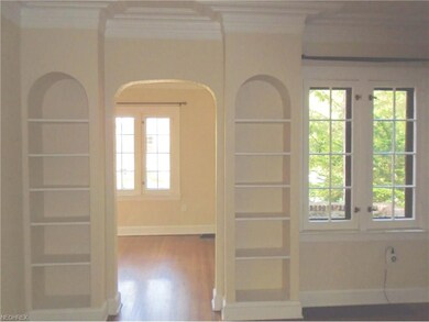 Arches and built in cabinets leads you from the li