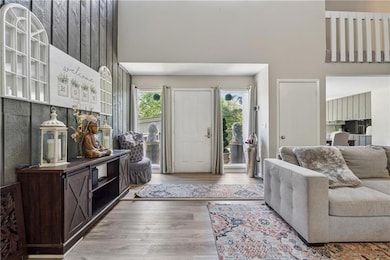 Living room with a high ceiling and wood finished floors