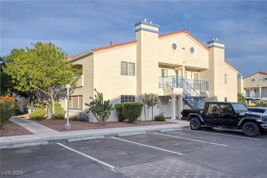 View of property featuring uncovered parking and s