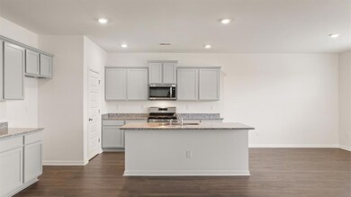 Kitchen featuring stove, dark hardwood / wood-styl