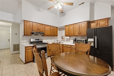 Kitchen featuring a ceiling fan, ventilation hood,