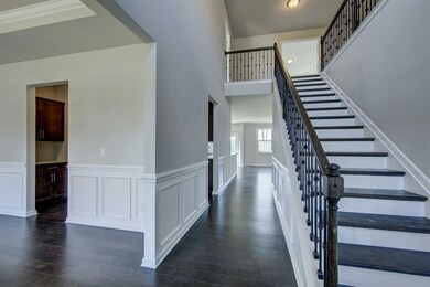 Front Entrance view.  Guests will be welcomed in a spacious foyer which opens to loft space and has elegant dining area to one side.  All photos are representative of a similar home.