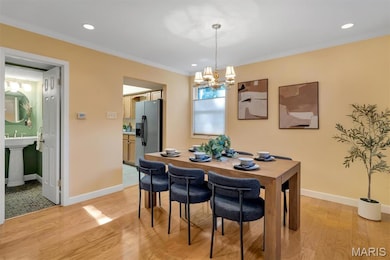 Dining space featuring light wood-type flooring, ornamental molding, recessed lighting