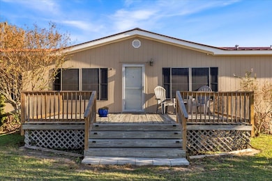Back of house featuring a wooden deck