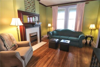 Living Room with Hardwood Floors & Decorative Fire