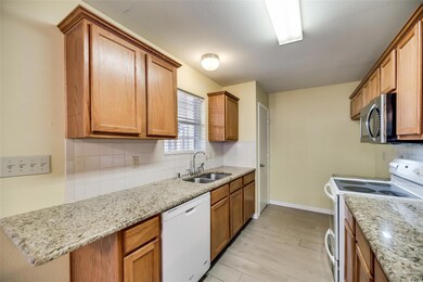 Kitchen featuring white appliances, sink, tasteful