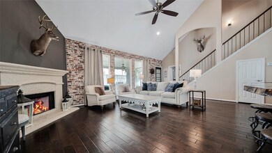 The living room boasts that exposed brick, as well as high ceilings, a beautiful fireplace, and an open flow into the kitchen for ease of entertaining.