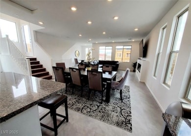 Dining room with recessed lighting, baseboards, an