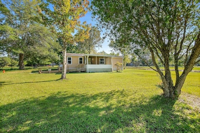 View of front of property featuring a front lawn and a deck