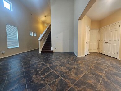 Unfurnished living room with stairway and a tower