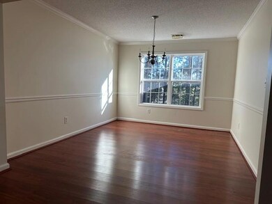 Unfurnished dining area with crown molding, a nota