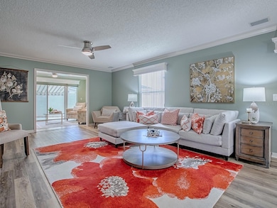 INVITING LIVING ROOM WITH FLORIDA ROOM IN BACKGROUND