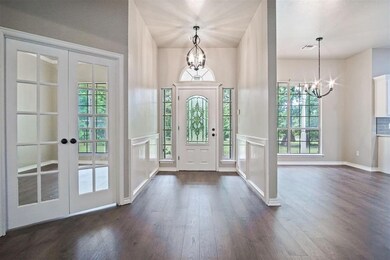 Foyer featuring dark wood-type flooring, french do