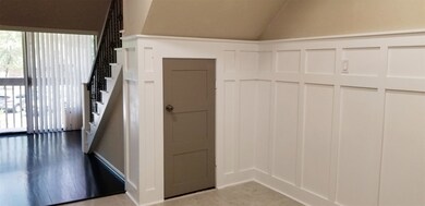 Functional and stylish wainscoting!  Smaller door