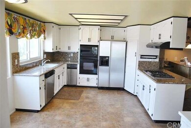 Remodeled kitchen with tile flooring and granite c