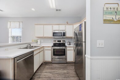 Kitchen featuring white cabinets, sink, kitchen pe