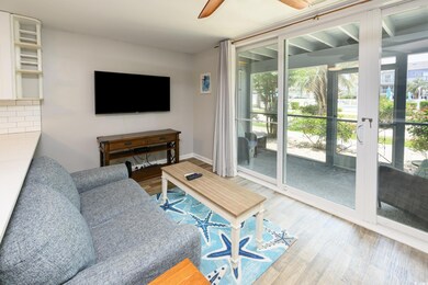 Living room featuring wood finished floors, ceiling fan, and baseboards